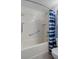 Bathroom showing a tub-shower with safety grab bar and a blue shower curtain at 5814 Silver Moon Ave, Tampa, FL 33625