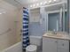 Bathroom with blue walls, a tub-shower with grab bar, and white fixtures at 5814 Silver Moon Ave, Tampa, FL 33625