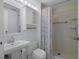 Bathroom featuring white fixtures, updated vanity, and shower with curtain at 5814 Silver Moon Ave, Tampa, FL 33625
