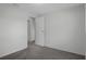 Bedroom showcasing neutral walls and carpet, with a visible doorway leading to another room at 5814 Silver Moon Ave, Tampa, FL 33625