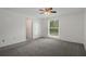 Bedroom features carpet, a ceiling fan, and a window with backyard view at 5814 Silver Moon Ave, Tampa, FL 33625