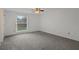 Bright, carpeted bedroom features a large window and ceiling fan at 5814 Silver Moon Ave, Tampa, FL 33625