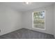 Simple bedroom with gray carpet and a bright window with views at 5814 Silver Moon Ave, Tampa, FL 33625