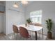 Bright dining room featuring a modern table set, closet, and plant near the window at 5814 Silver Moon Ave, Tampa, FL 33625