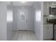 Bright foyer with tile flooring, leading to a well-equipped kitchen with modern appliances at 5814 Silver Moon Ave, Tampa, FL 33625