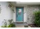 Charming front door with stone accents, potted plants, and decorative light fixture at 5814 Silver Moon Ave, Tampa, FL 33625