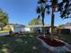 Charming single-story home features a well-manicured lawn, vibrant landscaping, and inviting curb appeal at 5814 Silver Moon Ave, Tampa, FL 33625