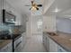 Well-lit kitchen featuring granite countertops, modern appliances, and tiled backsplash at 5814 Silver Moon Ave, Tampa, FL 33625