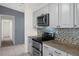 Galley-style kitchen featuring stainless steel appliances and tile backsplash at 5814 Silver Moon Ave, Tampa, FL 33625