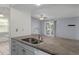 An open kitchen layout showing granite counters, double sinks, and stainless steel appliances at 5814 Silver Moon Ave, Tampa, FL 33625