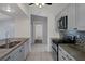 Modern kitchen featuring granite countertops, stainless steel appliances, and tile flooring at 5814 Silver Moon Ave, Tampa, FL 33625