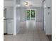 Open-concept living area with tile flooring, ceiling fan, and sliding glass doors to the outdoor space at 5814 Silver Moon Ave, Tampa, FL 33625