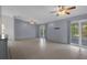 Open-concept living room featuring neutral walls, tile flooring, and sliding glass doors to a screened patio at 5814 Silver Moon Ave, Tampa, FL 33625