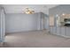 Open living area with tile flooring and a ceiling fan, complemented by a view of the kitchen at 5814 Silver Moon Ave, Tampa, FL 33625