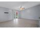 Bright living area with tile flooring, sliding glass doors to the patio, and a ceiling fan at 5814 Silver Moon Ave, Tampa, FL 33625