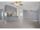 Spacious open-plan living area with tile flooring and a breakfast bar connecting to the adjacent kitchen at 5814 Silver Moon Ave, Tampa, FL 33625