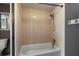 Bathroom featuring tan tiling in the shower and white fixtures at 6462 92Nd N Pl # 804, Pinellas Park, FL 33782