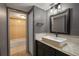 A bathroom featuring dark cabinets, a neutral granite counter and ceramic tile floors at 6462 92Nd N Pl # 804, Pinellas Park, FL 33782