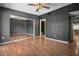 This bedroom features hardwood floors, a ceiling fan and a large mirrored closet at 6462 92Nd N Pl # 804, Pinellas Park, FL 33782