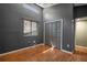 Cozy bedroom featuring wood floors, closet, window and neutral gray walls at 6462 92Nd N Pl # 804, Pinellas Park, FL 33782
