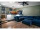 Spacious living room with a large blue sectional, open to the kitchen at 6462 92Nd N Pl # 804, Pinellas Park, FL 33782