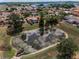This beautiful aerial view captures homes with swimming pools and a nearby pond surrounded by lush green trees at 8742 Bermuda Ln, Port Richey, FL 34668