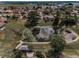 Aerial view of a pond and neighboring homes with lush trees and a picturesque landscape in the distance at 8742 Bermuda Ln, Port Richey, FL 34668