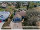 Aerial view of a charming home with pool in the backyard and pond at 8742 Bermuda Ln, Port Richey, FL 34668