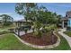 Well-maintained backyard featuring a gazebo, deck, mature trees and lush landscaping at 8742 Bermuda Ln, Port Richey, FL 34668