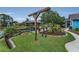 Charming backyard featuring a swing set, gazebo, and lush greenery, perfect for outdoor enjoyment at 8742 Bermuda Ln, Port Richey, FL 34668