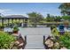 Spacious backyard deck overlooking a serene pond and gazebo with outdoor furniture at 8742 Bermuda Ln, Port Richey, FL 34668