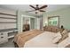 Relaxing bedroom featuring soft green walls, natural light, and ample storage at 8742 Bermuda Ln, Port Richey, FL 34668