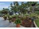 Lushly landscaped backyard with deck at 8742 Bermuda Ln, Port Richey, FL 34668