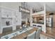Open dining room with built-in glass shelving flowing into a kitchen with stainless steel appliances and granite countertops at 8742 Bermuda Ln, Port Richey, FL 34668