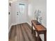 Entryway with wood-look flooring and a glass paneled white front door at 8742 Bermuda Ln, Port Richey, FL 34668