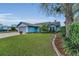 Charming light-blue house features a well-maintained lawn and landscaping at 8742 Bermuda Ln, Port Richey, FL 34668