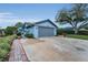 Light-blue house with well-manicured landscaping and a gray two-car garage at 8742 Bermuda Ln, Port Richey, FL 34668