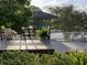 Backyard gazebo with furniture, lake view, and landscaping at 8742 Bermuda Ln, Port Richey, FL 34668