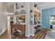 A pass-through kitchen is shown with dark counter tops, wood cabinets and wood flooring at 8742 Bermuda Ln, Port Richey, FL 34668