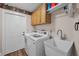 Functional laundry room with modern appliances, ample storage, and easy outdoor access at 8742 Bermuda Ln, Port Richey, FL 34668