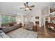 Comfortable living room featuring wood floors, vaulted ceilings, and lots of natural light at 8742 Bermuda Ln, Port Richey, FL 34668