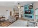 Bright living room featuring a vaulted ceiling, luxury vinyl floors, and a decorative fireplace at 8742 Bermuda Ln, Port Richey, FL 34668