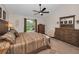 Comfortable main bedroom featuring a ceiling fan, neutral color palette, and beautiful furnishings at 8742 Bermuda Ln, Port Richey, FL 34668