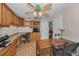 Spacious office featuring custom built-ins, wood floors, and a decorative ceiling fan at 8742 Bermuda Ln, Port Richey, FL 34668
