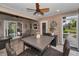 Relaxing screened-in patio with wood-paneled walls, ceiling fan, and outdoor dining set at 8742 Bermuda Ln, Port Richey, FL 34668