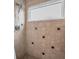 Tiled shower stall with patterned accents, a shower head, and a frosted glass window at 8742 Bermuda Ln, Port Richey, FL 34668