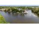 Aerial view of a waterfront home with a dock, lush greenery, and tranquil waters at 9001 Tudor Dr # H210, Tampa, FL 33615