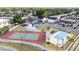 Aerial view showcasing the community pool, tennis court, and surrounding landscape at 9001 Tudor Dr # H210, Tampa, FL 33615