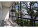 Enjoy the scenic waterfront view from this screened-in balcony with a black metal railing at 9001 Tudor Dr # H210, Tampa, FL 33615