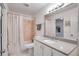 Bright bathroom featuring a shower-tub combination, white vanity, and modern mirror at 9001 Tudor Dr # H210, Tampa, FL 33615